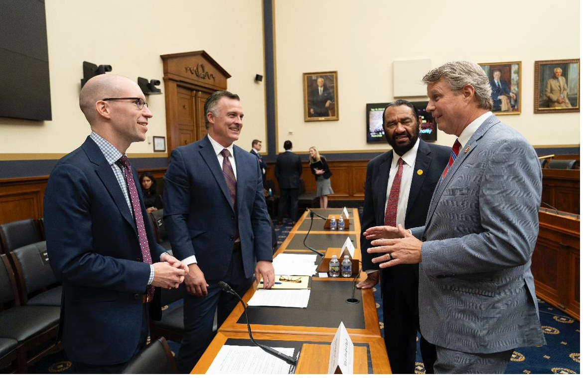 Tim Doyle with Charles Crain of the National Association of Manufacturers and Representatives Bill Huizenga and Al Green after testifying before the House Financial Services Committee